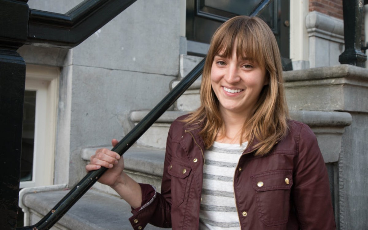 a woman holding a bat on top of a building