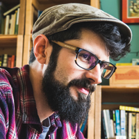 a man looking at a book shelf
